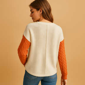 Gebreide damestrui met kabelpatroon en zakdetail, losvallende pasvorm en verlaagde schouders, perfect voor casual en stijlvolle combinaties.