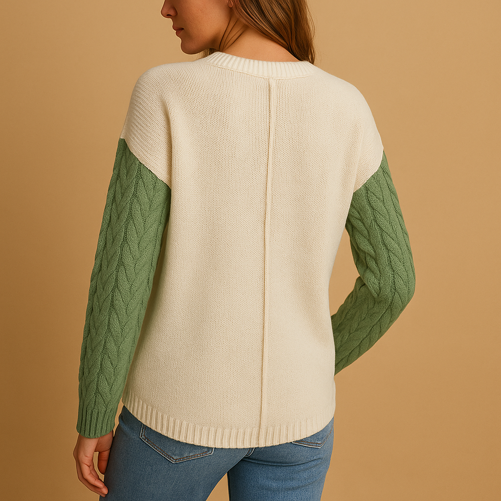 Gebreide damestrui met kabelpatroon en zakdetail, losvallende pasvorm en verlaagde schouders, perfect voor casual en stijlvolle combinaties.